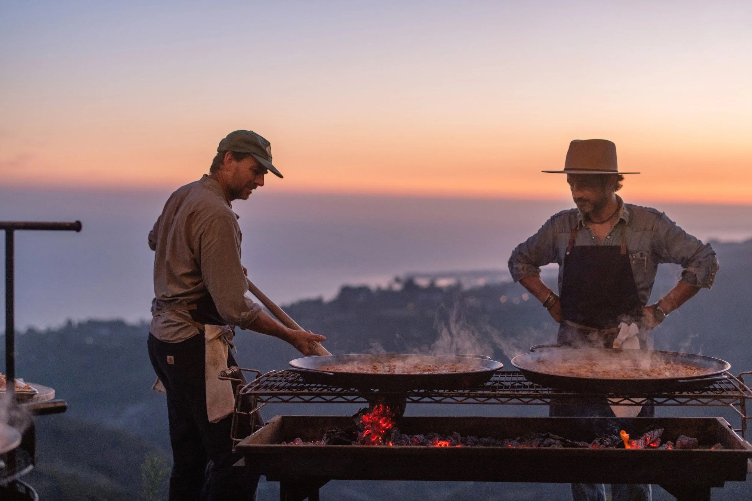 Chef Sébastien grilling paella at sunset